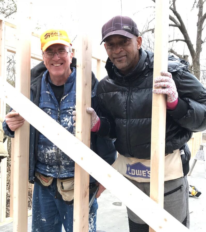 Two volunteers at a Habitat construction site.